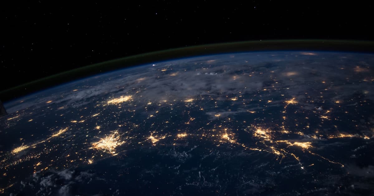 Earth photographed at night, showing networks of city lights
